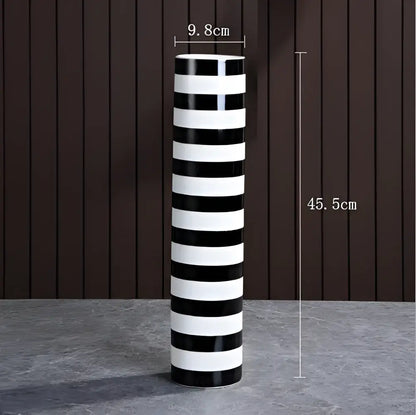 A tall elegant striped ceramic vase with bold black and white stripes for modern living room decorbites decor