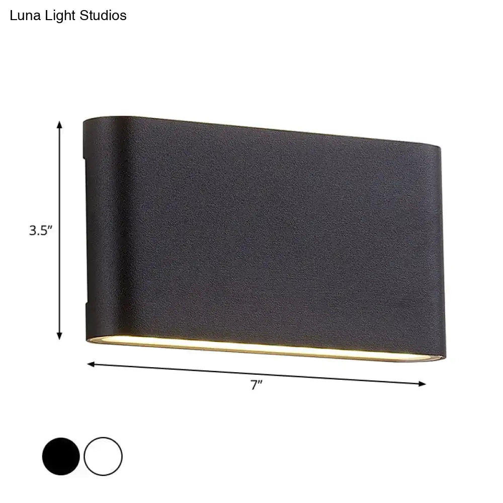 Modern black flush mount wall lamp with textured finish and warm bottom glow for bedroom sconce light use