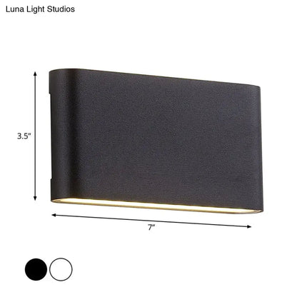 Modern black flush mount wall lamp with textured finish and warm bottom glow for bedroom sconce light use