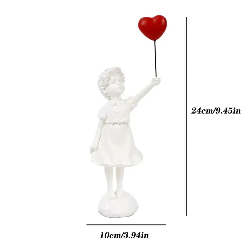 White resin figurine of a child in a dress holding a red flying love balloon for decorbites flying love decor