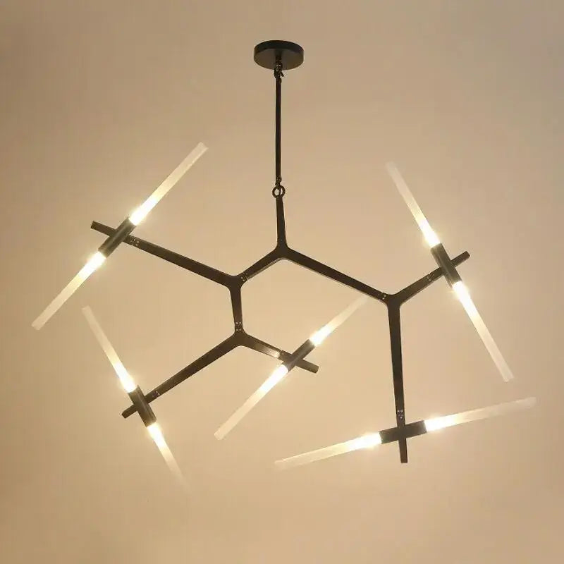 Modern black metal ceiling light with six illuminated frosted glass led rods in a geometric starburst pattern