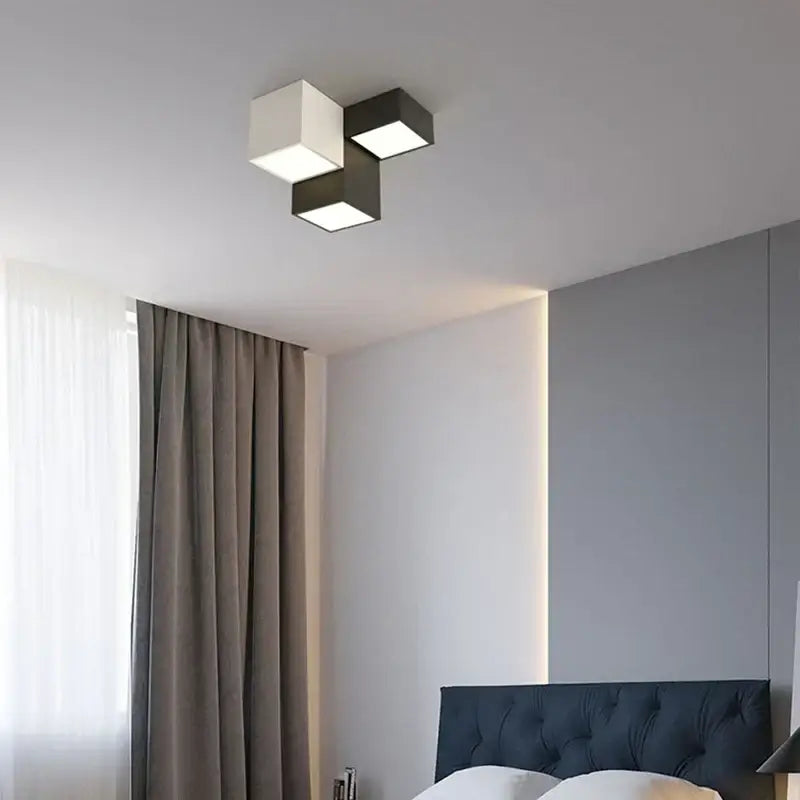 Modern black and white geometric led ceiling light with three cube panels emitting a soft warm glow for bedroom decorbites geometric led ceiling