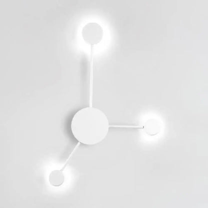 Minimalist white wall sconce light fixture with three glowing circular bulbs in a modern geometric design for living rooms