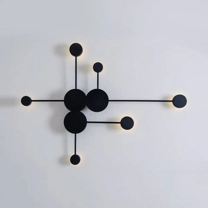 Modern black wall sconce light fixture with minimalist geometric design featuring interconnected circles and rods