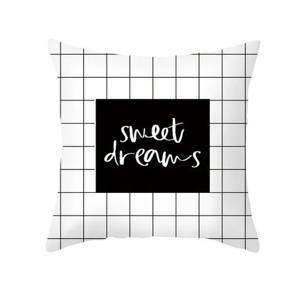 White throw pillow with black grid and central black square featuring sweet dreams in white cursive for home decor decorbites black geometry letters