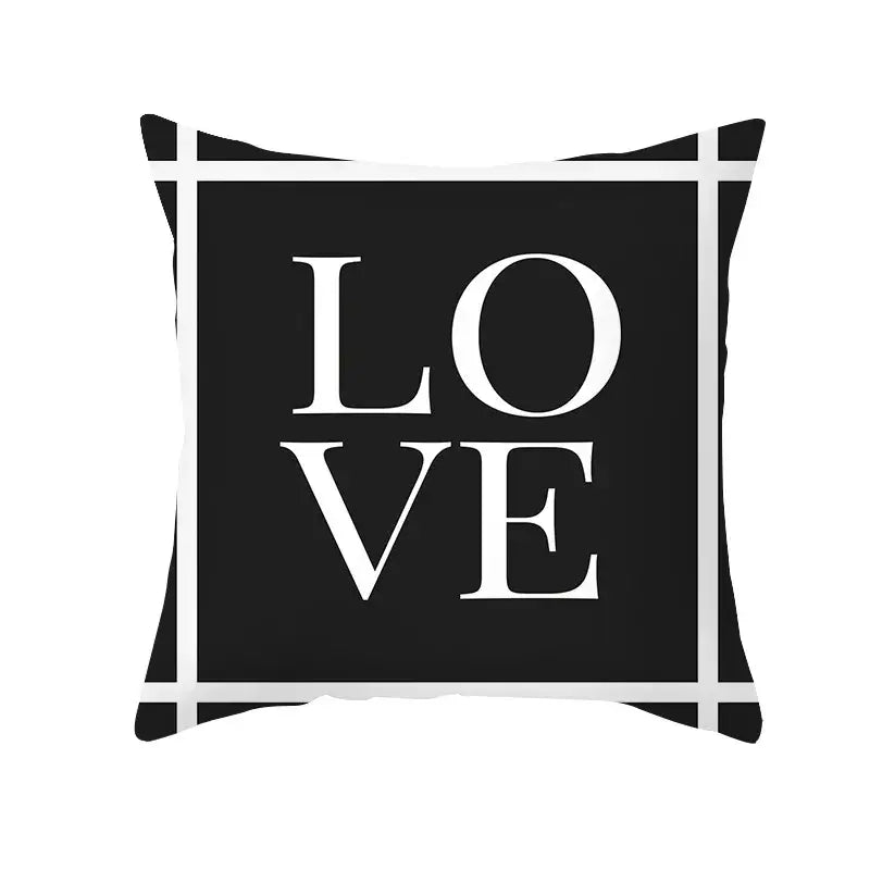 Black throw pillow with bold white love lettering and geometric grid pattern for modern home decor by decorbites black geometry letters