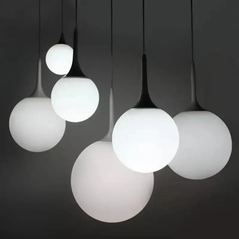 Modern black and white glass ball pendant lamp with frosted glass and black metal stems for dining room lighting decorbites glass ball