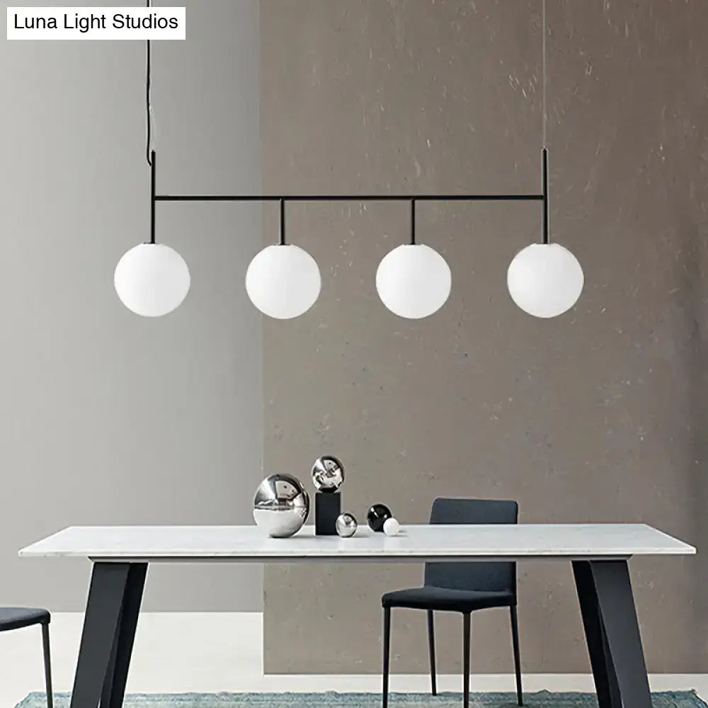 Decorbites contemporary black metal pendant light with four frosted white glass orb globes for island lighting