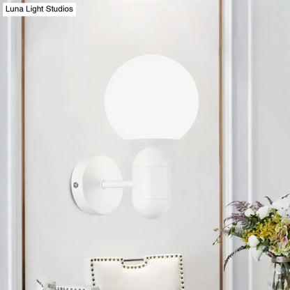 Modern black and white glass wall light featuring a white spherical globe minimalist wall lamp for meeting rooms