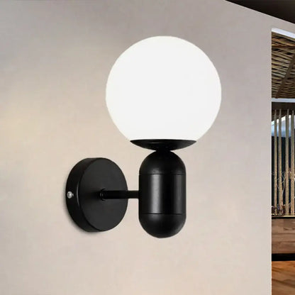 Modern black spherical wall lamp with frosted glass globe designed as a glass wall light for meeting rooms