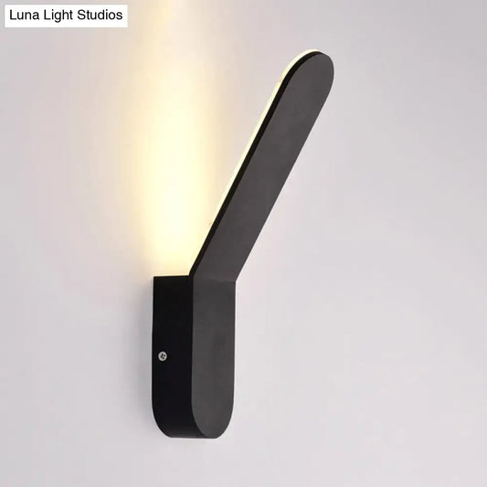 Modern black and white oval shape led lighting wall sconce with sleek angular design emitting warm light for corridors