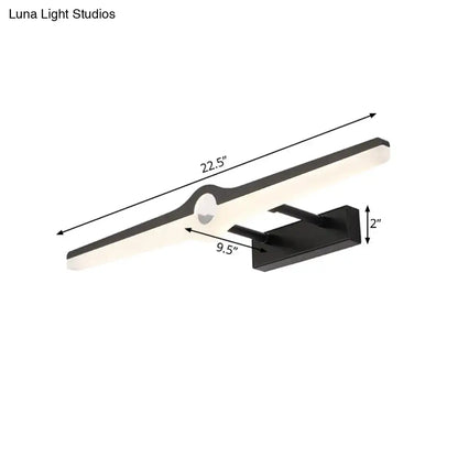 Modern black and white led wall sconce with sleek elongated design and integrated motion sensor for minimalist living room lighting