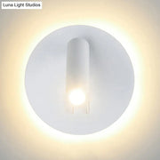Modern black white metal acrylic wall lamp with white circular sconce and cylindrical light emitting warm ambient glow