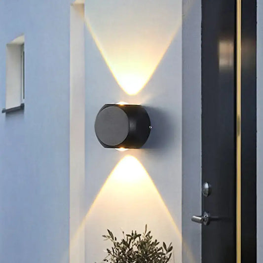 Modern black and white mini cube wall lamp with black cylindrical dual angled lights illuminating living room wall lamp