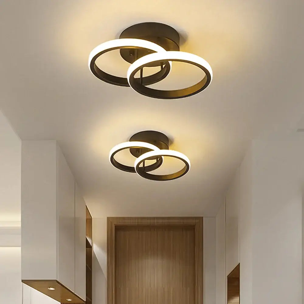 Modern black and white minimalist led ceiling light with two interlocking brushed brass rings warm glow decorbites led ceiling