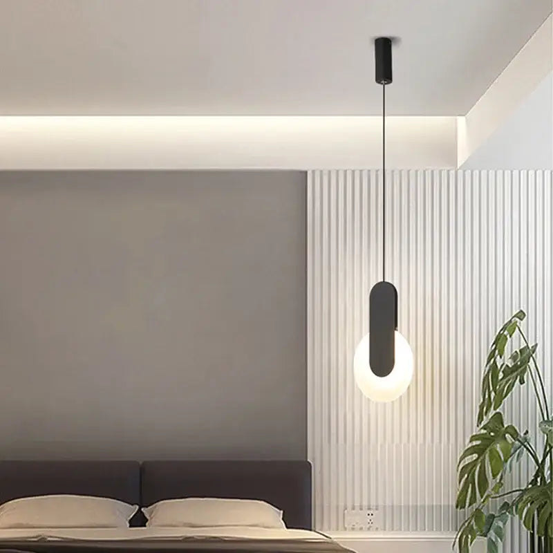 Modern black pendant light with frosted glass globe featuring led bulbs as a stylish dining room light source