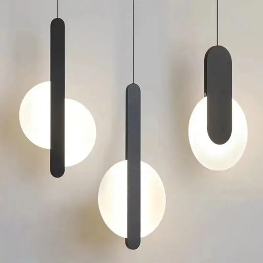 Three modern black pendant lights with sleek rectangular shades and glowing led bulbs as a dining room light source