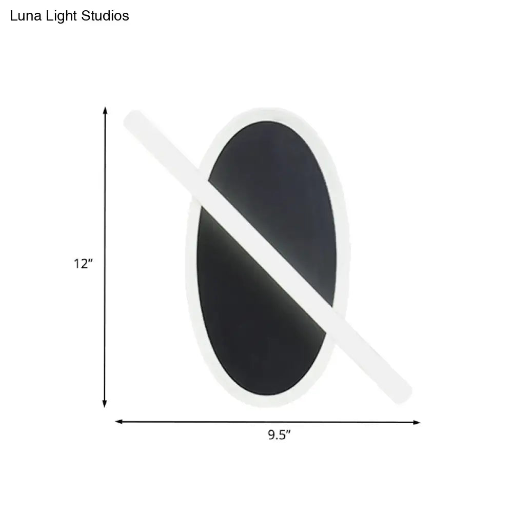 Modern black and white oval led sconce with diagonal light bar and warm white glow for stairway lighting