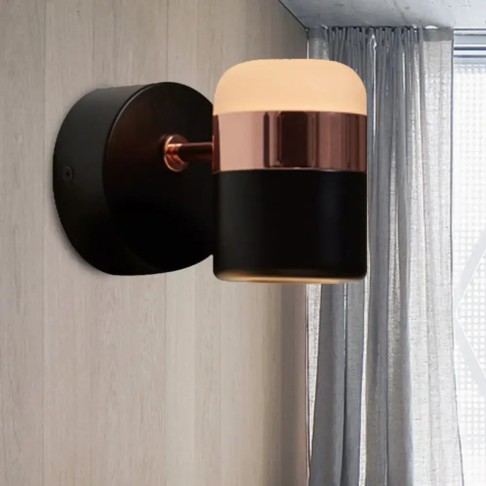 Modern black white rotatable led spotlight wall sconce with sleek black and rose gold finish and warm cylindrical lampshade glow
