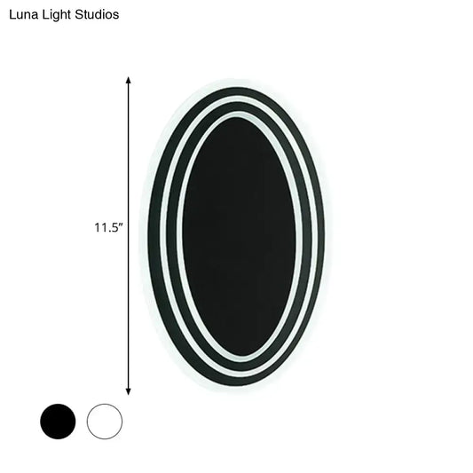 Modern black and white rotatable led wall light fixture with a sleek double-rimmed oval mirror for bedroom wall light