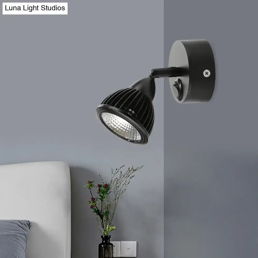 Modern black and white wall light with matte finish, ribbed adjustable head, and circular base for bedroom spotlight