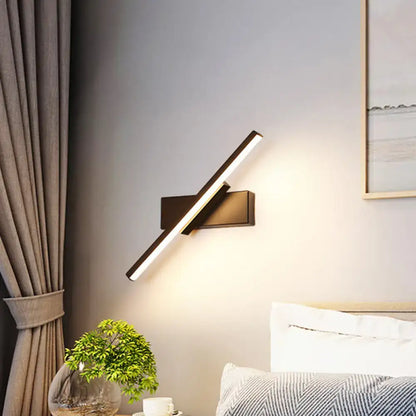 Modern black and white slim led wall sconce with sleek angular design and warm white illumination for bedroom lighting