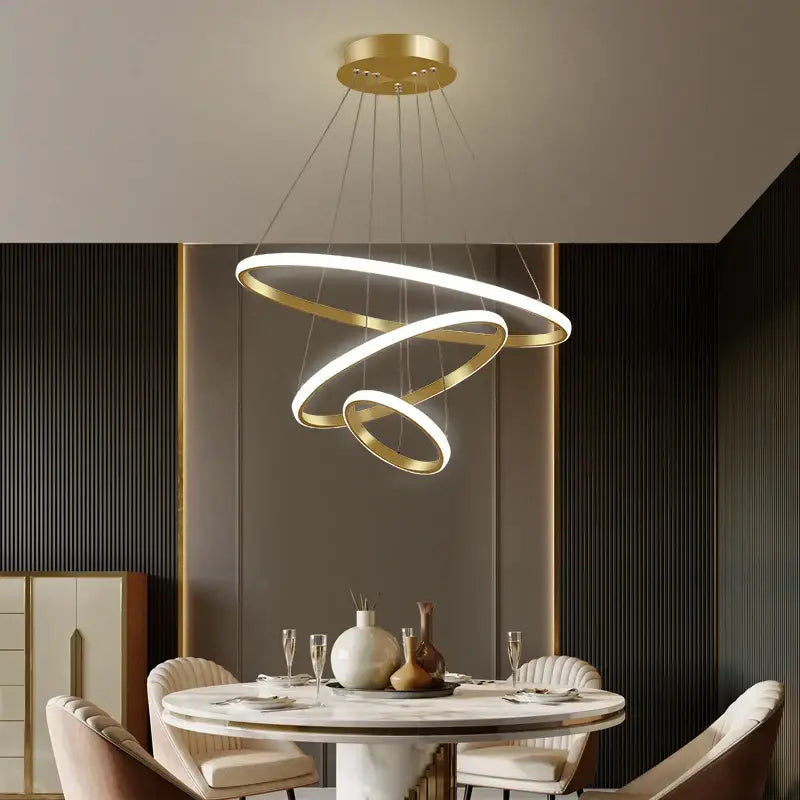 Gold-toned spiral pendant chandelier with illuminated led rings suspended from circular ceiling mount decorbites black ring
