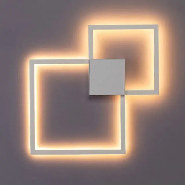Modern black and white square led wall sconce with warm glowing light for bedroom lighting and wall decor