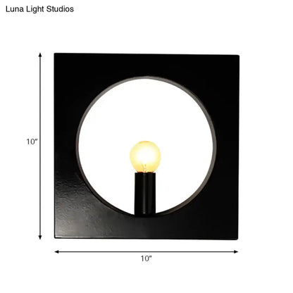 Modern black wall lamp with glass globe fixture and circular cutout framing illuminated medium base bulb inches fixture