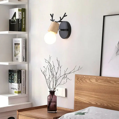 Modern black wooden wall light with antler design and warm glowing bulb perfect for living room decorbites black wooden wall sconce