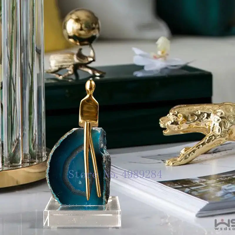 A sleek golden crystal golden sculpture on vibrant blue agate crystal mounted on clear acrylic for living room decorbites agate crystal
