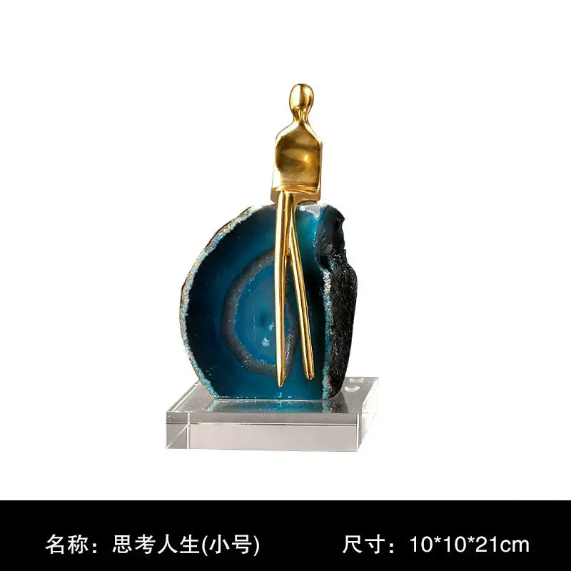 A sleek golden crystal sculpture on a vibrant blue black agate crystal golden slice for modern decorbites decor