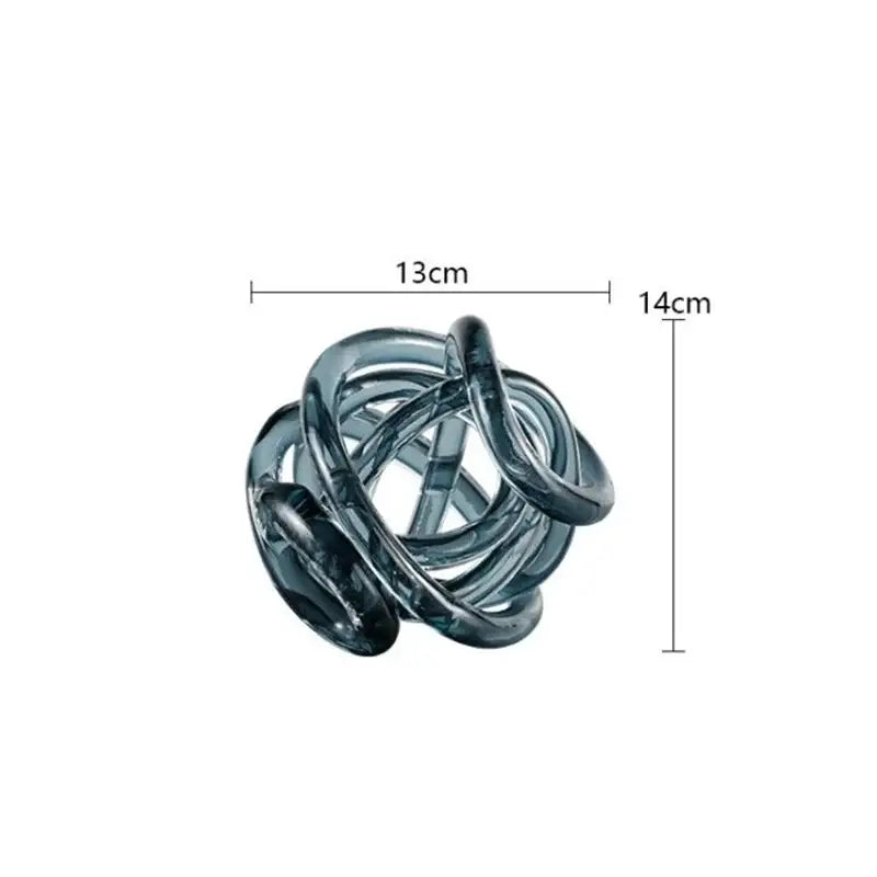 A sleek transparent blue glass coil ball decorative figurine with intertwined loops for modern living room decor