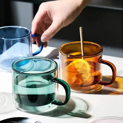 Modern blue amber and green glass mugs set features clear double-walled glass mugs in vibrant hues with matching handles