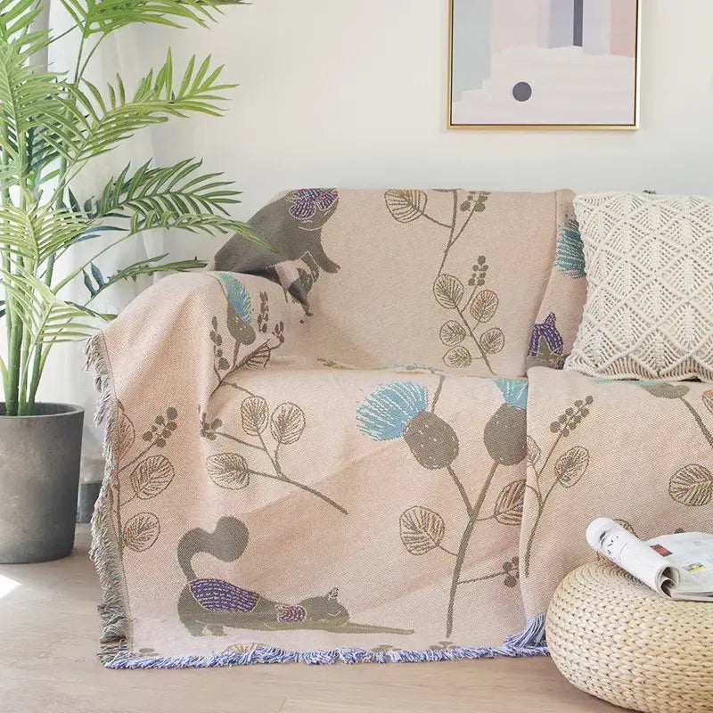 Beige throw blanket with embroidered squirrels and botanical motifs in muted blues for decorbites cartoon cat sofa cover decorbites cartoon