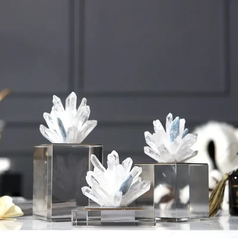 Modern blue crystal flower marble base sculpture features clear quartz clusters with subtle blue inclusions on sleek bases