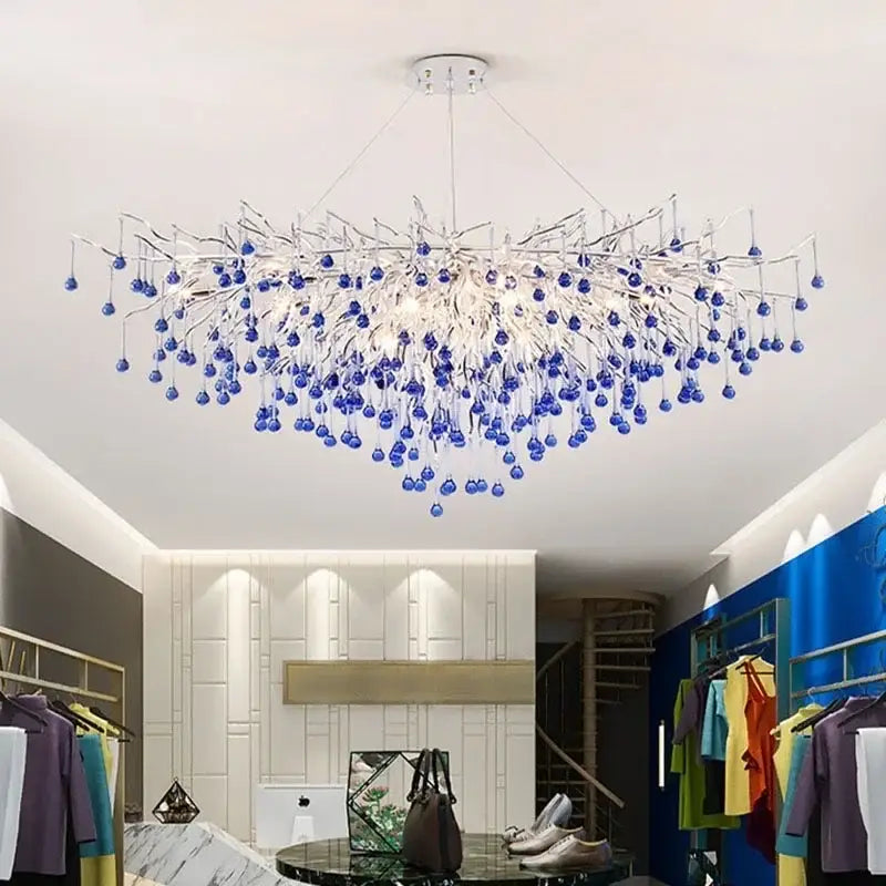 A modern pendant light featuring blue crystal led orbs on silver-toned metal arms for elegant living room decorbites blue crystal