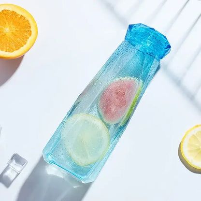 Modern blue diamond water bottle translucent faceted design filled with ice and citrus for kitchen and sport travel
