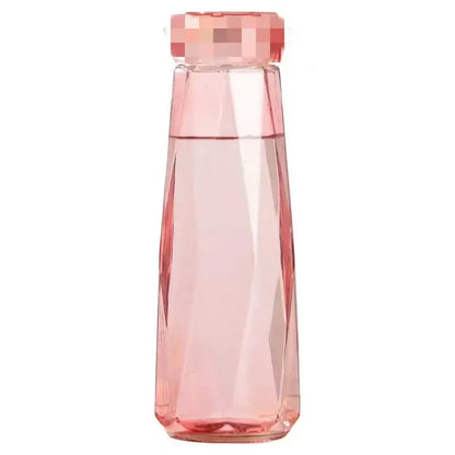 Modern blue diamond water bottle in translucent pink faceted glass with geometric cap for kitchen and sport travel