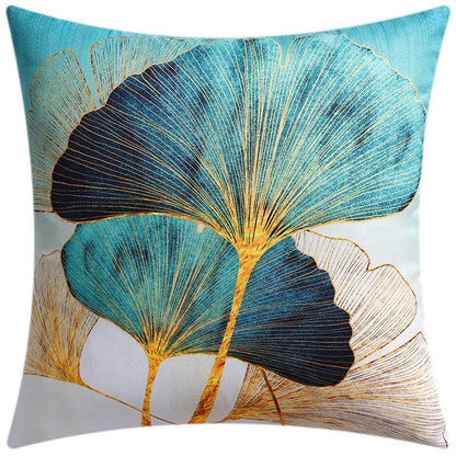 Square cushion cover featuring stylized teal and navy blue ginkgo leaves with gold outlines for modern blue floral decorbites blue floral decor