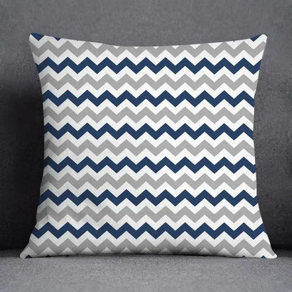 Square throw pillow with bold navy blue light gray and white chevron pattern featuring a geometric floral design
