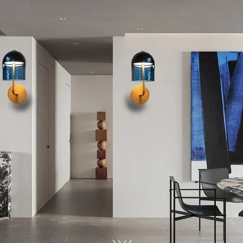 Modern blue glass dome wall sconce lamp with gold-toned base, a stylish wall sconce lamp for bedroom lighting