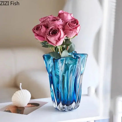 A vibrant blue glass hydroponic vase with a fluted design holds pink roses for modern office decorbites decor