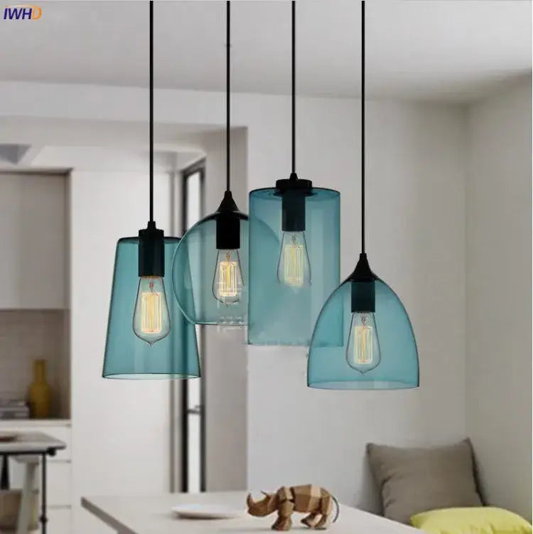 Set of four teal glass led pendant lights with black metal fixtures and exposed filament bulbs for dining room lighting