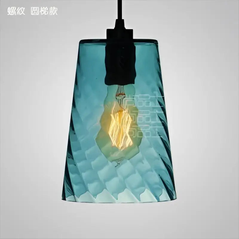 Modern blue glass led pendant lamp featuring a textured teal glass led pendant with exposed filament bulb for dining room lighting