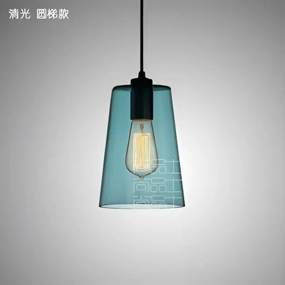 Teal glass led pendant lamp with black metal fixture and exposed filament bulb for modern dining room lighting