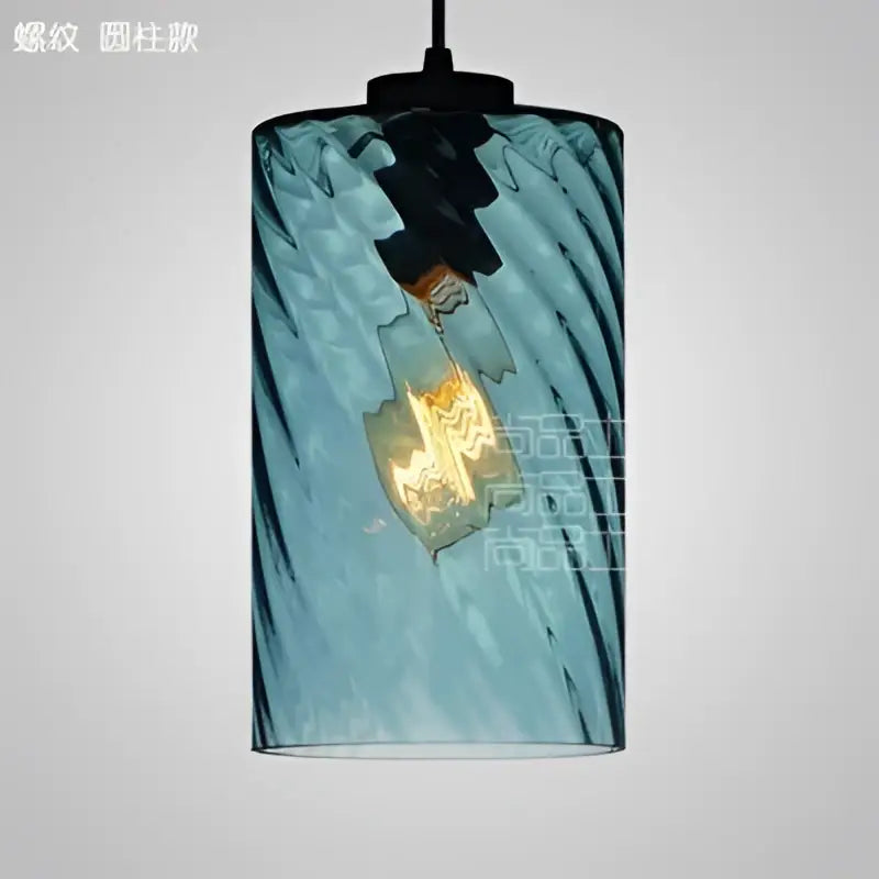 Modern blue glass led pendant lamp featuring a twisted design with visible filament bulb for dining room lighting