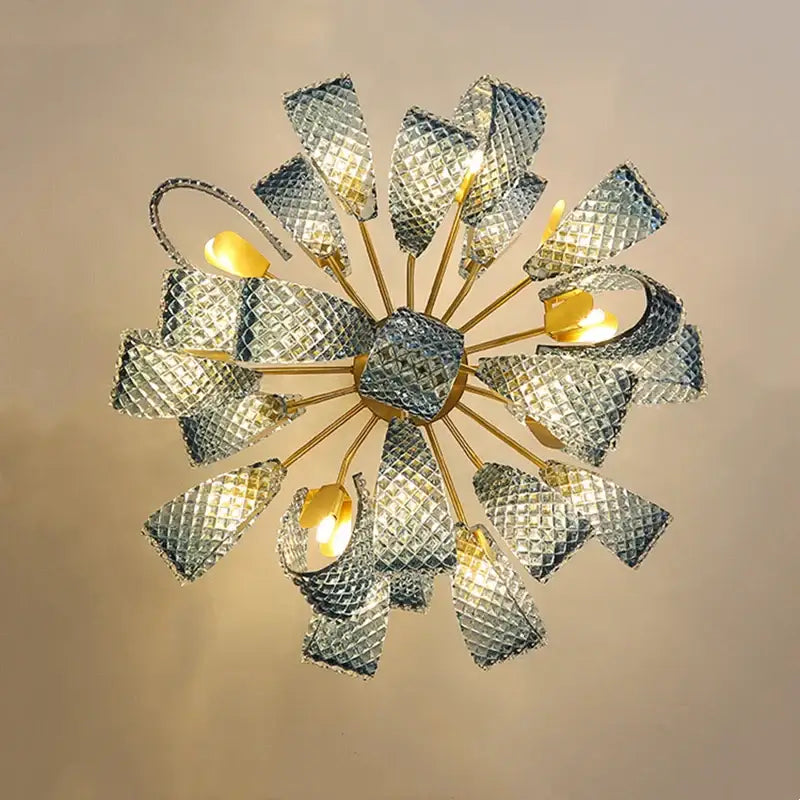Modern blue glass led pendant lamps featuring a brass hub with radiating arms and faceted silver petal shades by decorbites