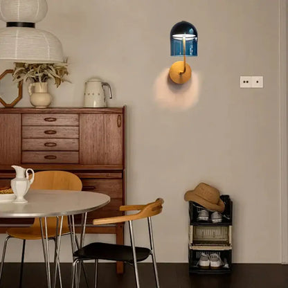 Modern blue glass wall lamp with gold-toned circular brass base for stylish bedroom decorbites blue glass wall lighting