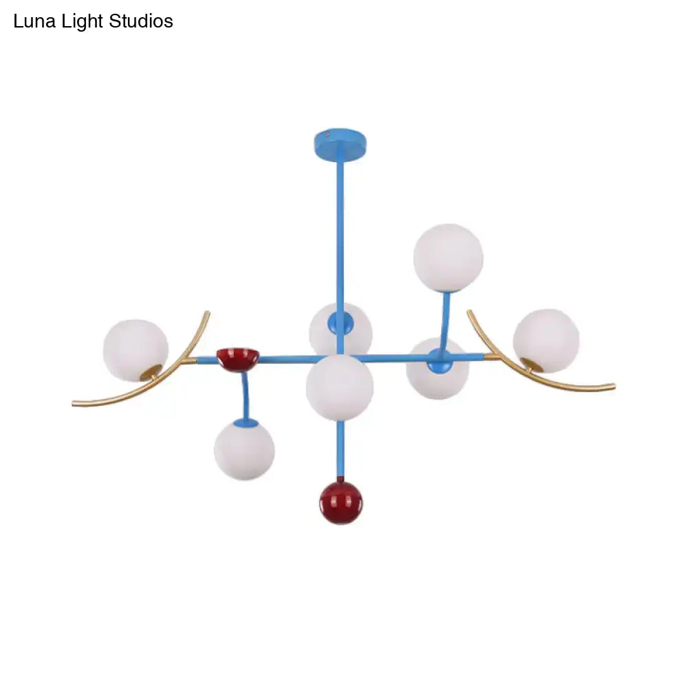 Modern blue and gold lamp fixture with opal glass ball shades and red accents for dining room glass ball island lighting